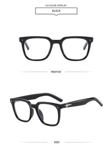 Detail view of black square frame sunglasses with silver star rivets on the front and side