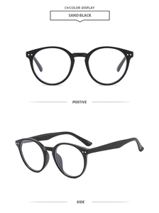 Detail of sand black round sunglasses with classic silver rivet studs on the frame