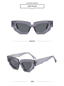 Detail of grey cat eye sunglasses with thick geometric frames and dark lenses