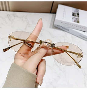 Detail showing rimless oval tea lens with gold F-shaped crystal decoration
