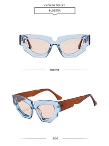 Detail of trendy blue cat eye sunglasses with sharp geometric frames and tea lenses