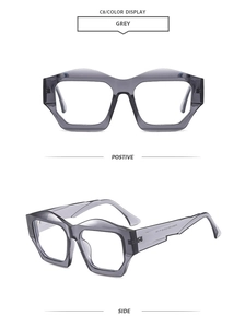 Detail view of grey irregular hexagonal sunglasses with modern translucent frames