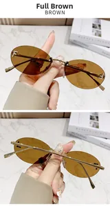 Detailed macro view of rimless brown oval sunglasses with crystal F logo and gold temples