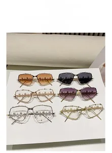 Detailed grid of oversized rhinestone sunglasses with gradient lenses and gold metal frames