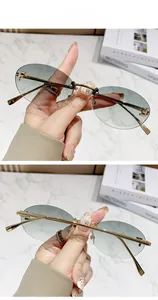 Detailed view of rimless oval sunglasses with green gradient lenses and gold F-logo temple