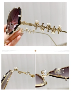 Detail of gold metal sunglasses with purple gradient lenses and sparkling rhinestones