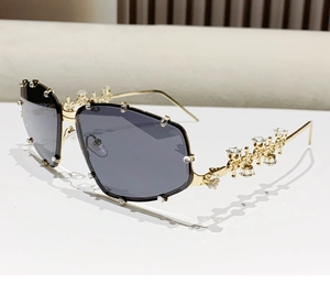 Detail of gold metal temples with sparkling rhinestones on luxury oversized sunglasses
