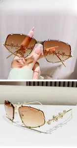 Detail view of double brown gradient lenses and gold rhinestone crown on sunglasses