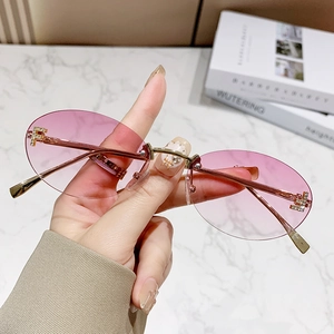 Fashion rimless oval sunglasses with pink gradient lenses and gold metal temples