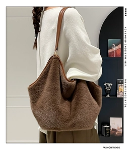 Brown faux fur tote bag detail showing soft plush texture and leather shoulder strap