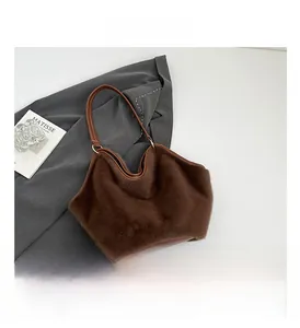 Detail of soft brown faux fur texture and leather shoulder strap with metal ring