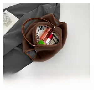 Top view of plush leopard tote bag showing capacity with phone, bottle, and umbrella