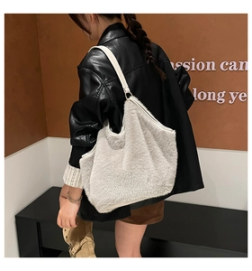 Detail view of plush tote bag in off-white with white leather shoulder strap