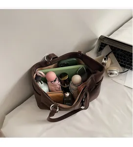 Interior view of brown tote bag showing large capacity for tablet, umbrella, and essentials