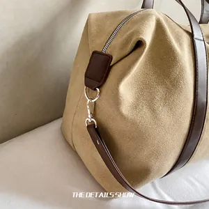 Detalle de ganchos metálicos y correas de cuero en el bolso de lona de estilo retro