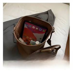 Top view showing large interior capacity of brown lychee leather tote with inner pouch