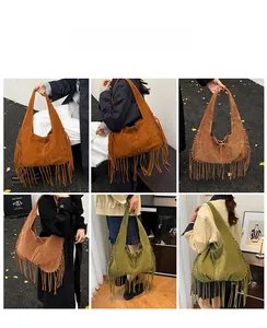 Detail of bohemian large suede hobo bag with fringe in dark brown and vintage green colors