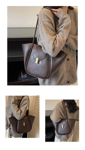 Detail of dark brown faux leather tote with golden buckle and textured finish
