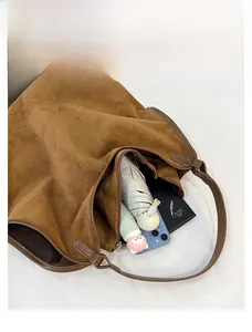 Top-down view showing spacious interior of brown suede tote bag for daily essentials