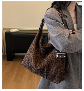 Detailed view of leopard print hobo bag with side zipper and studded leather strap