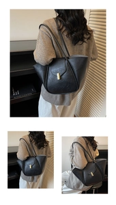 Macro detail of black leather tote bag with vintage texture and gold metal buckle