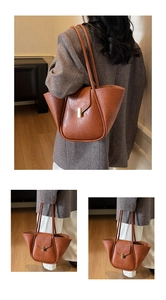 Close-up of caramel tote bag with lychee texture leather and gold metal lock detail
