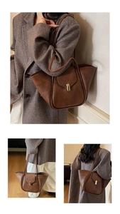 Close-up of vintage dark brown faux leather tote bag with gold rectangular clasp detail