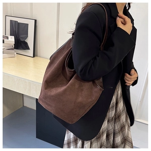 Brown suede tote bag shown on a model for a stylish oversized look and large capacity