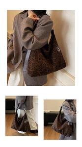 Detail view of large leopard print tote bag with brown leather straps and silver zipper