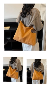 Detail of suede leopard print tote showing side metal zipper and ginger matte texture