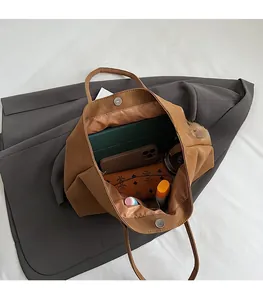 Top view of spacious brown matte leather tote bag interior with daily essentials