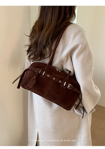 Deep brown matte leather shoulder bag styled with a minimalist vintage coat for women