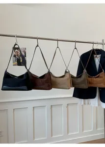 Detailed display of suede hobo bags in five colors on a rack for fashion choices