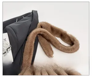 Detail of soft brown faux fur shoulder strap with elegant gold metal hooks on a cloud bag