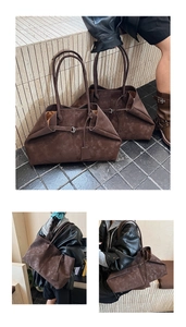 Close-up of vintage dark brown suede tote bags with metal buckle and shoulder strap detail