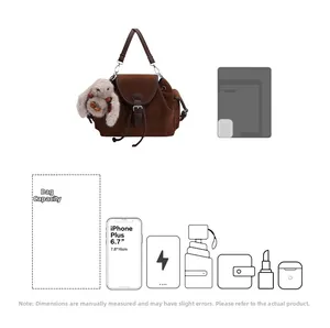 Detail view of brown suede bucket bag interior capacity showing fits for iPad and phone