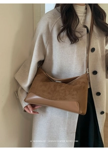 Detail of brown vintage suede and leather stitching on a minimalist shoulder bag