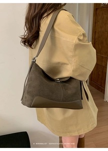 Model wearing a brown suede crescent bag with a khaki trench coat for a vintage aesthetic