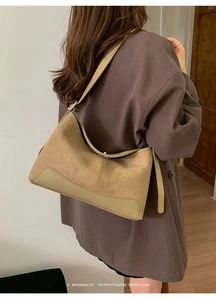 Brown matte suede hobo bag styled by a model in a minimalist indoor setting