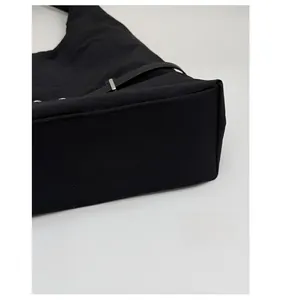 Detail view of reinforced bottom stitching on this minimalist black canvas tote bag