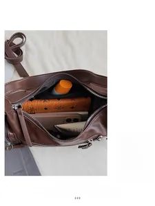 Interior view of brown leather bag showing spacious capacity and smooth metal zipper