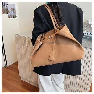 Detailed view of brown oversized tote bag with soft matte texture and slouchy design