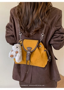 Retro mustard yellow mini backpack with brown trim and cute plush bunny charm