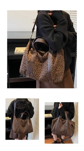 Close-up detail of leopard print tote bag featuring brown leather straps and wide shoulder band
