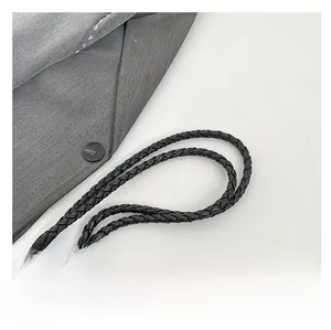 Detail shot of the woven black leather handles on a large stylish hobo shoulder bag