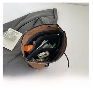 Interior view of brown suede tote bag showing large capacity and black woven handle