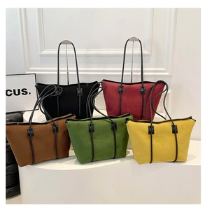 Detailed lineup of large contrast color tote bags in black, burgundy, tan, green and yellow