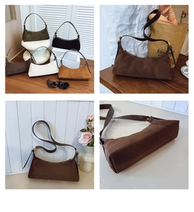 Detail view of stylish suede underarm bags in multiple colors with leather straps