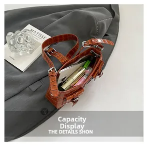Caramel crocodile pattern leather bag showing interior capacity for phone and makeup