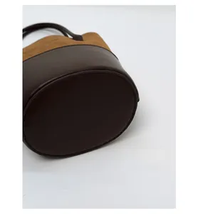 Close-up of the reinforced oval base on this vintage suede bucket bag with stitching